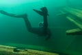 SCUBA diver entering the cabin trunk of wooden schooner shipwreck Royalty Free Stock Photo