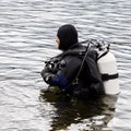 Scuba diver enters the mountain lake water. practicing techniques for emergency rescuers. immersion in cold water Royalty Free Stock Photo