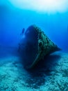 Scuba diver explores a sunken ship wreck