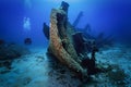 A scuba diver explores a sunken shipwreck Royalty Free Stock Photo