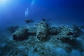 A scuba diver explores a sunken world war two fighter propeller airplane