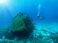 Scuba diver is exploring a sunken wreck Royalty Free Stock Photo