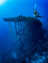 A scuba diver in front of an sunken shipwreck