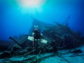 Scuba diver in front of a sunken shipwreck Royalty Free Stock Photo