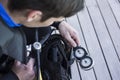 Scuba diver kitting up and checking the pressure gauge