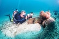 Scuba diver photographing corals