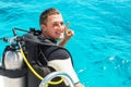 Scuba diver is preparing for diving into blue water from the boat. Underwater equipment Royalty Free Stock Photo