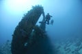 Scuba diver at the propellor area of a shipwreck. Royalty Free Stock Photo