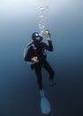 A scuba diver is underwater at a safety stop