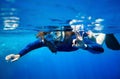 Scuba diver woman in blue water. Royalty Free Stock Photo