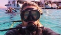 Scuba diver woman making selfie in the water after diving