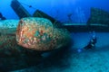 SCUBA divers around an aircraft wreck Royalty Free Stock Photo