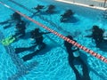 Scuba divers exercising an underwater scuba diving in a swimming pool