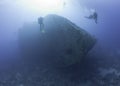 Scuba divers exploring a shipwreck Royalty Free Stock Photo