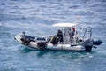 Scuba divers going over the side of a RIB to dive at sea in Playa Blanca, Lanzarote, Spain