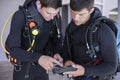 Scuba divers kitting up and checking their gear