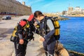 Scuba divers performing an equipment check before diving.