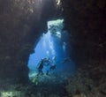 Scuba divers in an underwater cavern Royalty Free Stock Photo