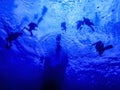 SCUBA Divers Underwater at Safety Stop Below Ship Royalty Free Stock Photo