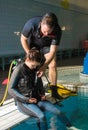 Scuba diving course pool teenager girl with instructor in the water Royalty Free Stock Photo