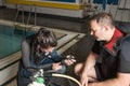 Scuba diving course pool teenager girl with instructor in the water Royalty Free Stock Photo