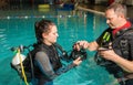 Scuba diving course pool teenager girl with instructor in the water Royalty Free Stock Photo