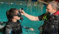 Scuba diving course pool teenager girl with instructor in the water Royalty Free Stock Photo