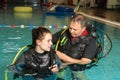 Scuba diving course pool teenager girl with instructor in the water Royalty Free Stock Photo