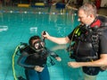 Scuba diving course pool teenager girl with instructor in the water Royalty Free Stock Photo