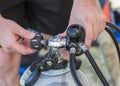 Scuba diving equipment close up of a man attaching an A-clamp