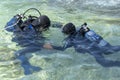 Scuba Diving Instructor Teaching a Little Boy to Dive Royalty Free Stock Photo