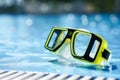 Scuba diving mask in hotel swimming pool Royalty Free Stock Photo