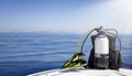 A scuba diving tank and gear standing on a boat bow Royalty Free Stock Photo