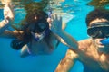 Scuba diving, underwater or couple swimming to explore for marine adventure, hobby or vacation activity. Mask, divers or Royalty Free Stock Photo