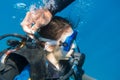 Scuba instructor opened the air valve on wetsuit for immerse Royalty Free Stock Photo