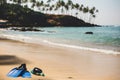 Scuba mask with flippers on the beach sand. Blue fins on the sandy beach Royalty Free Stock Photo