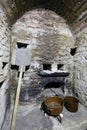 Scullery with stoneware dishes, shovel and fireplace