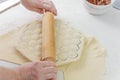 Prepare homemade dumplings on the table, sprinkled with flour.