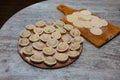 Sculpt pierogy and pelmeni concept. Include rustic cutting board, making pierogies on a rustic wooden table. dumplings