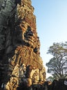 Sculpted face of a deity on a tower of Bayon temple in Angkor historical complex, Siem Reap, Cambodia. Royalty Free Stock Photo