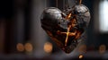 A sculpted heart, appearing charred and cracked, is suspended by strings or wires. Royalty Free Stock Photo