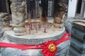 sculpted vase and incense sticks in a chinese temple (wak hai cheng bio) and modern buildings - singapore Royalty Free Stock Photo