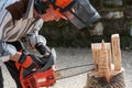 The sculptor carves the wood with the chainsaw Royalty Free Stock Photo