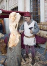 Sculptor carving a sculpture of a woman in a woode