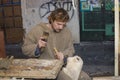 Sculptor carving a sculpture of a woman in a woode