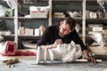 The sculptor conducts restoration work in a plaster workshop. Restoration of the gypsum head of Apollo