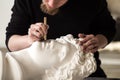 The sculptor conducts restoration work in a plaster workshop. Restoration of the gypsum head of Apollo