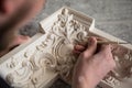 The sculptor creates a bas-relief. Plaster workshop. Close up. Selective focus