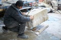 Sculptor gem-worker lifts a crane a piece of marble.