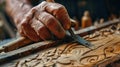 Sculptor hand working with wood carving with chisel making sculpture Royalty Free Stock Photo